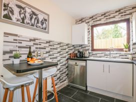 A kitchen with a table and chairs at Camellia Cottage Bodmin