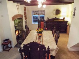 A dining room with a table and chairs at Tyddyn Gyrfa Cottage in Cemaes Bay