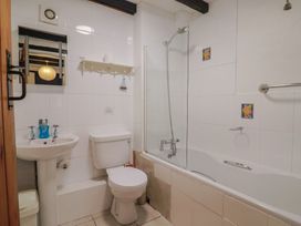 A bathroom with a sink, toilet, and bathtub at Apple Cottage in Whitchurch Canonicorum