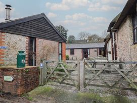 An outdoor area with buildings and a gate at Apple Cottage in Whitchurch Canonicorum