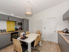 A kitchen with a table and chairs at Blencathra Family in Penrith