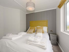 A bedroom with a bed and bedside table at Blencathra Family in Penrith
