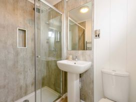 A bathroom featuring a shower, sink, and toilet at Blencathra Family in Penrith