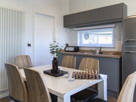 A dining room with a table and chairs at Blencathra Family (Pet) in Penrith