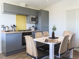 A kitchen with a dining table and chairs at Blencathra Family (Pet) in Penrith