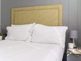 A bedroom with a bed and lamps at Blencathra Family (Pet) in Penrith