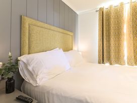 A bedroom with a bed and curtains at Grasmere in Penrith