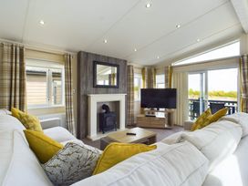 A living room with a sofa and TV at Keswick in Penrith