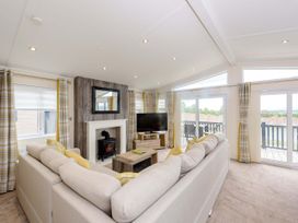 A living room with a television and fireplace at Keswick in Penrith