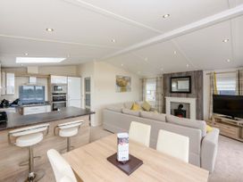 A living room with a kitchen and dining area at Keswick in Penrith