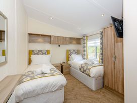 A bedroom with twin beds and a wardrobe at Keswick in Penrith