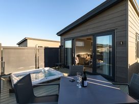 An outdoor area with a hot tub and seating at Grasmere (Pet) Penrith