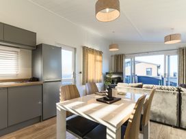 A kitchen with a table and chairs at Grasmere (Pet) in Penrith