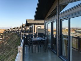 A deck with table and chairs at Keswick (Pet) Penrith