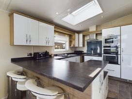 A kitchen with cabinets and appliances at Keswick (Pet) Penrith