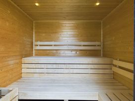 A sauna with wooden benches and walls at Spa Sauna Lodge (Pet) Penrith