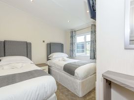 A bedroom with two beds and a window at Helvellyn in Penrith