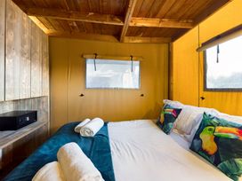 A bedroom with a bed and decorative pillows at Savannah (Pet) Penrith