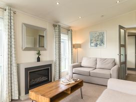 A living room with a sofa and table at Helvellyn (Pet) in Penrith