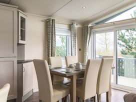 A dining room with a wooden table and chairs at Helvellyn (Pet) Penrith