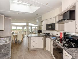 A kitchen with a table and chairs at Helvellyn (Pet) Penrith