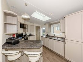 A kitchen with cabinets and a countertop at Helvellyn (Pet) Penrith