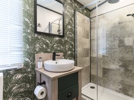 A bathroom with a sink and shower at Blencathra Spa (Pet) in Penrith