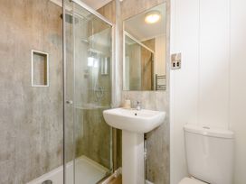 A bathroom with shower and sink at Blencathra Spa (Pet) in Penrith
