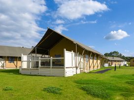 A group of tents with a deck in an outdoor setting at Kruger in Penrith