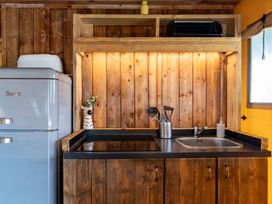 A kitchen with a refrigerator and sink at Kruger in Penrith