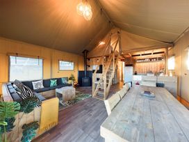 A living room with a sofa and dining table at Kruger in Penrith