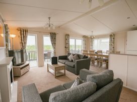 A living room with a sofa and television at Scaféll in Penrith