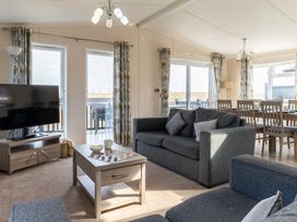 A living room with a sofa and television at Scaféll (Pet) in Penrith