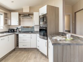 A kitchen with cabinets and appliances at Scaféll (Pet) in Penrith