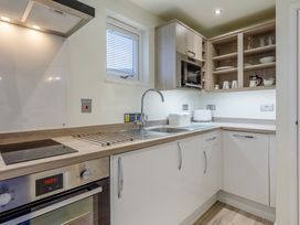 A kitchen with a sink and cooking appliances at Lakeside Studio Pet in Portreath