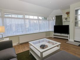 A living room with a television and a coffee table at Renes Shop in Grange-Over-Sands