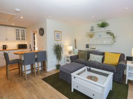 A living room with a sofa and dining area at Renes Shop in Grange-Over-Sands