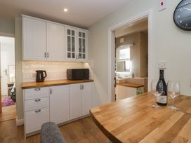 A kitchen with a microwave and kettle at Renes Shop in Grange-Over-Sands