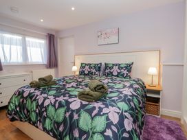 A bedroom with a double bed and bedside lamps at Renes Shop in Grange-Over-Sands