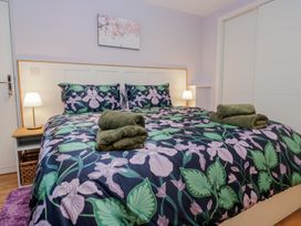 A bedroom with a bed and bedside table at Renes Shop in Grange-Over-Sands