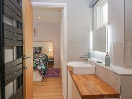 A bathroom with a sink and mirror at Renes Shop in Grange-Over-Sands
