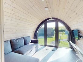 A room with a sofa and a television at Pod 2 (No Pets) in Carnforth