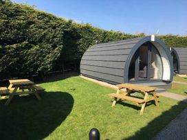 An outdoor area with pods and picnic tables at Pod 2 (No Pets) Carnforth