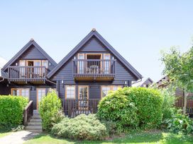 A house with balconies and greenery at Scandinavian Lodge 4 in Portreath