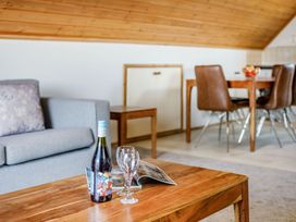 A living room with a sofa and a dining table at Scandinavian Lodge 4 Portreath