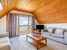 A living room with a sofa and coffee table at Scandinavian Lodge 4 Portreath