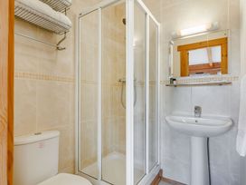 A bathroom with a shower, toilet, and sink at Scandinavian Lodge 4 in Portreath