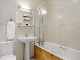 A bathroom with a sink, toilet, and bathtub at Scandinavian Lodge 4 Portreath