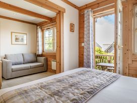 A bedroom with a bed and a sofa at Scandinavian Lodge 4 in Portreath