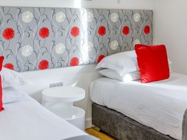 A bedroom with two beds and a decorative headboard at Signature Lodge Pet 4 Portreath